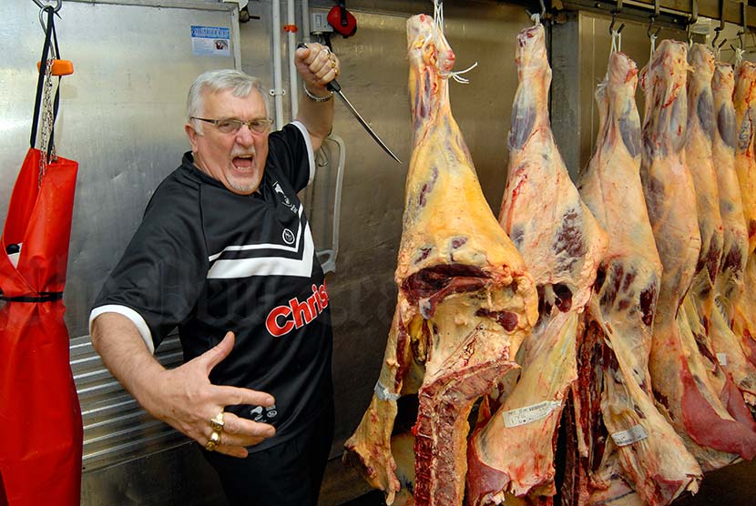 butcher with beef carcass